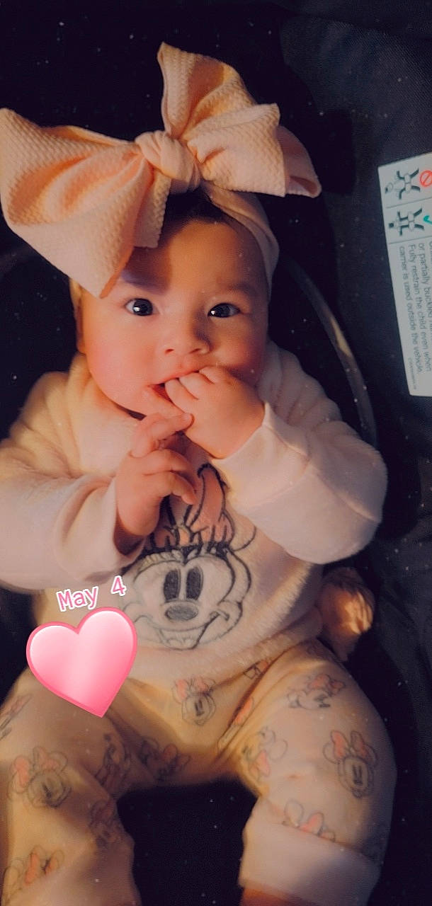 Amelie is registered to the contest to win money with this photo: arm, baby_toddler_clothing, cheek, ear, eye, eyelash, finger, gesture, hand, happy, head, human, human_body, iris, lip, mouth, neck, nose, organ, person