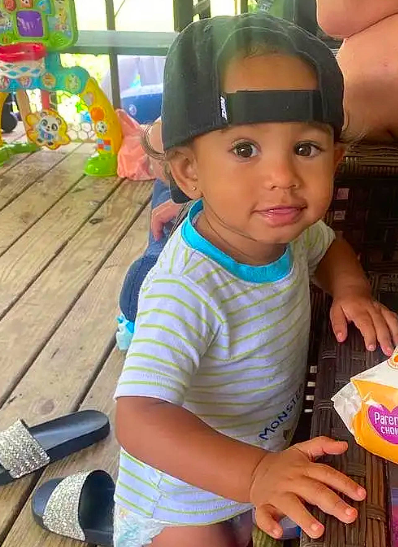 Sean is registered to the contest to win money with this photo: baby_toddler_clothing, baseball_cap, blue, cap, child, electric_blue, fun, hand, happy, leisure, person, personal_protective_equipment, play, recreation, sitting, skin, summer, t_shirt, thumb, toddler