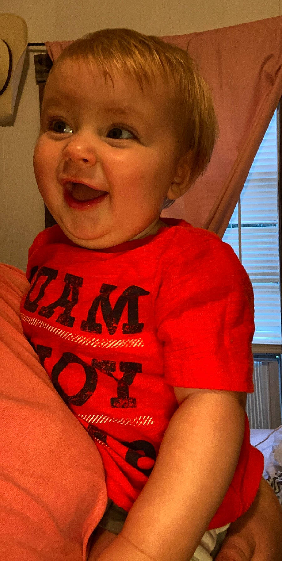 Laine is registered to the contest to win money with this photo: baby, cheek, child, chin, face, facial_expression, laugh, lip, mouth, neck, nose, person, skin, smile, t_shirt, toddler, tooth