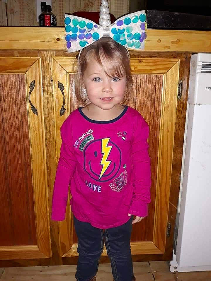 Jessa is registered to the contest to win money with this photo: baby_toddler_clothing, cabinetry, clothing, eye, face, facial_expression, hair, happy, head, human_body, leg, organ, outerwear, party_hat, person, pink, product, purple, sleeve, textile