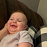 Havery Grace is registered to the contest to win money with this photo: baby, child, smiling, face, couch, hand, clothing, indoor, cheeks, happy, person, plaid, pillow, relaxing, comfort, infant, sitting, skin, head, tongue
