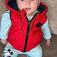 Kj Bourke joined the competition — help win amazing prizes! baby, child, red_vest, gold_chain, mickey_mouse, pants, socks, couch, seated, curious, indoor, face, blue_eyes, clothing, infant, portrait, cute, fashion, casual, comfort