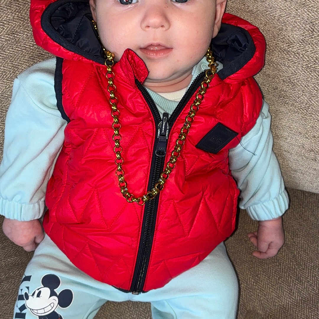 Kj Bourke joined the competition — help win amazing prizes! baby, blue_eyes, casual, child, clothing, comfort, couch, curious, cute, face, fashion, gold_chain, indoor, infant, mickey_mouse, pants, portrait, red_vest, seated, socks
