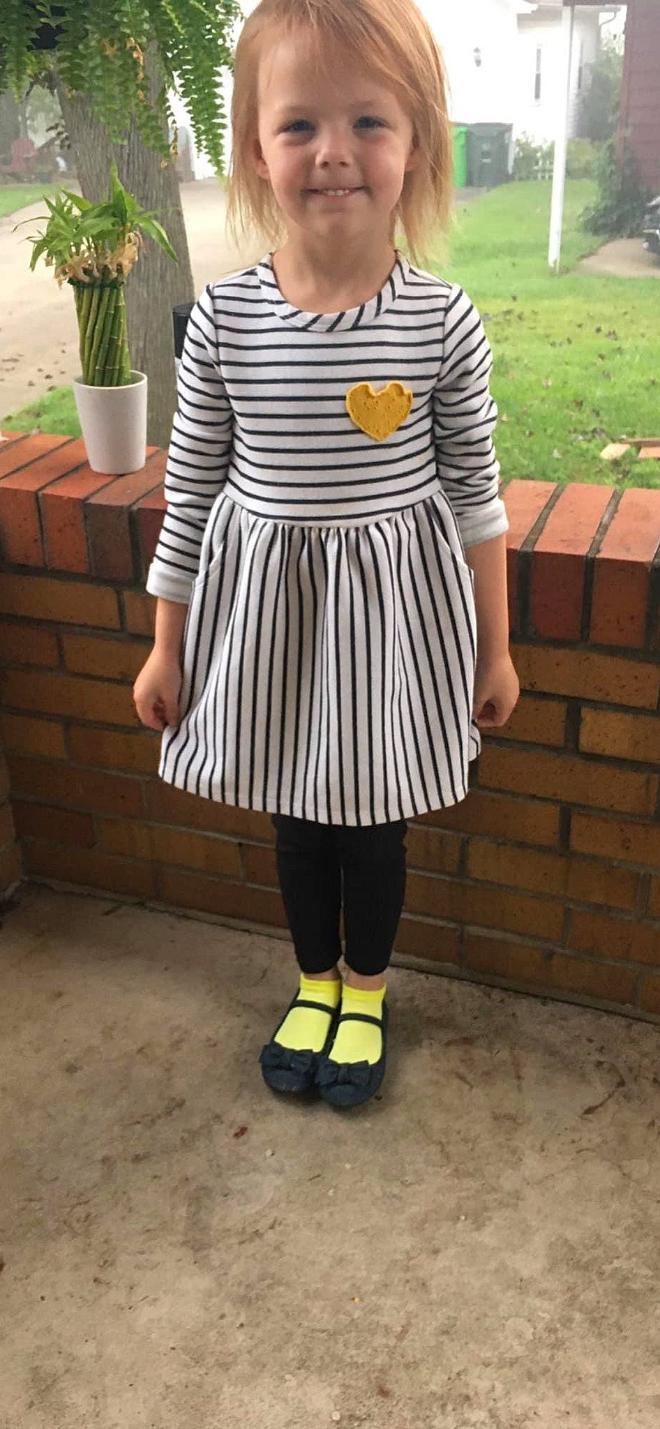 Adelaide is registered to the contest to win money with this photo: day_dress, electric_blue, eyewear, fashion_accessory, fashion_design, flowerpot, grass, houseplant, human_leg, joy, knee, magenta, neck, pattern, person, plant, sleeve, t_shirt, textile, thigh