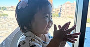 Kai Yumi joined the competition — help win amazing prizes! baby, bunny_pattern, child, cityscape, dark_hair, daylight, hair_clip, hands, happy, highchair, indoor, outdoors, portrait, profile, reaching, sitting, skyline, smiling, toddler, window