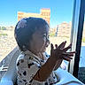 Kai Yumi joined the competition — help win amazing prizes! toddler, child, baby, smiling, happy, sitting, highchair, window, cityscape, skyline, outdoors, daylight, hair_clip, dark_hair, profile, hands, reaching, bunny_pattern, portrait, indoor