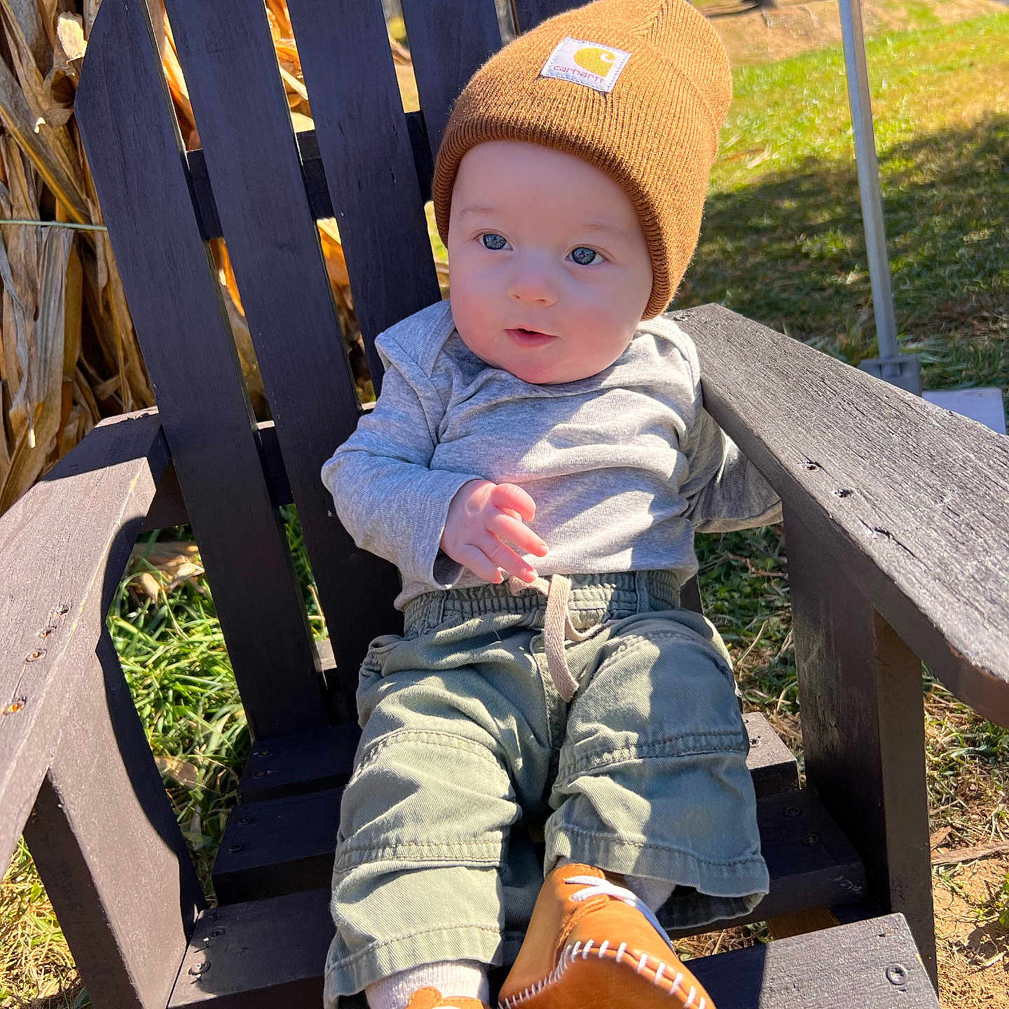 Jenson is registered to the contest to win money with this photo: baby, baseballcap, beanie, bench, cap, chair, clothing, face, footwear, furniture, hat, head, jeans, pants, person, photography, portrait, shoe, sitting, wood