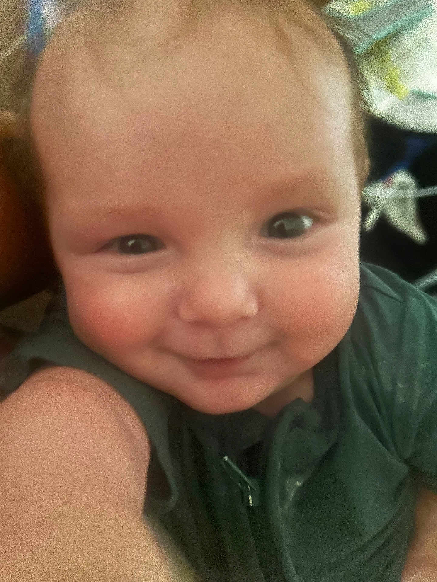 Kessler joined the competition — help win amazing prizes! baby, baby_garment, child, chubby_cheeks, close_up, cute, expression, eyes, face, green_clothing, happy, head, indoor, infant, person, portrait, selfie, skin, smile, young_child