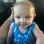 Kessler is registered to the contest to win money with this photo: baby, blue_clothing, car_seat, child, comfort, cute, expression, face, hair, hand, indoor, infant, person, portrait, seagull_pattern, seatbelt, skin, smile, tank_top, tattoo