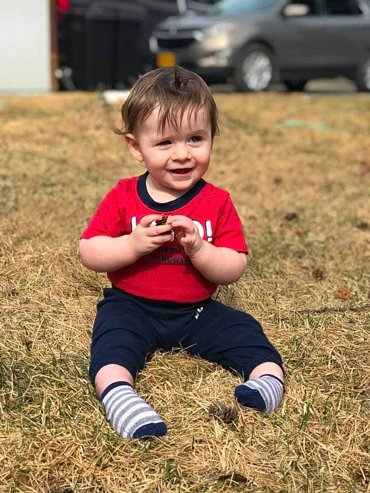 Oliver is registered to the contest to win money with this photo: baby, car, child, facial_expression, fun, grass, happy, joy, lawn, people, person, photography, plant, play, red, sitting, smile, soil, toddler, tree