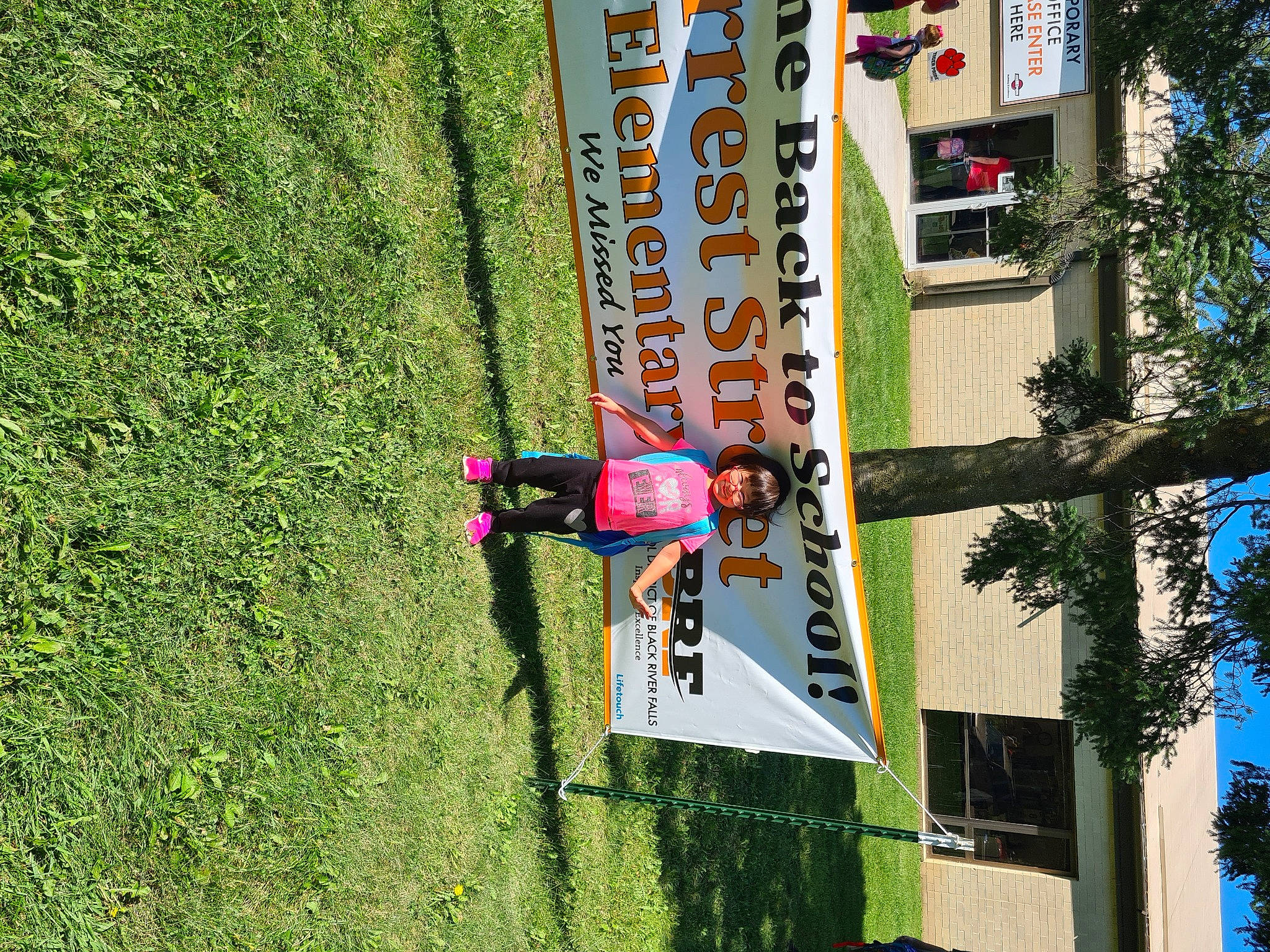 Sakura is registered to the contest to win money with this photo: adventure, advertising, biome, building, competition_event, extreme_sport, facade, fun, grass, house, leisure, person, plant, pole, recreation, sports, sports_equipment, tree, urban_design, window