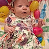 Serenity joined the competition — help win amazing prizes! baby, blanket, bow, child, colorful, cute, easter_eggs, floral_dress, hands, happy, headband, indoors, infant, laying_down, plastic_eggs, playful, portrait, smiling, soft_texture, young