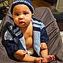 Brysan joined the competition — help win amazing prizes! baby, infant, child, knitted_hat, knitted_sweater, diaper, sitting, curious, indoors, soft_blanket, feet, hands, face, expression, cozy, warm_lighting, wooden_floor, furniture, home, portrait