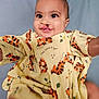 Brysan joined the competition — help win amazing prizes! baby, child, cleft_lip, smile, yellow_clothing, tiger_print, cute, portrait, indoor, person, happy, infant, young_child, fabric, pattern, playful, face, eyes, sitting, background