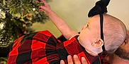 Aries is registered to the contest to win money with this photo: accessories, baby, blanket, bodypart, christmas, christmasdecorations, christmastree, conifer, face, festival, finger, hand, head, lighting, person, photography, plant, portrait, tartan, tree