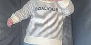 Eden participe au concours pour gagner de l'argent avec cette photo : adorable, baby, bear_socks, blue_pants, child, clothing, cute, expression, face, footwear, hair, indoor, infant, lying_down, pacifier, padded_surface, person, small_hands, striped_sweater, wearing