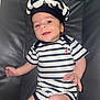 baby, casual, chair, child, cute, diaper, face, happy, hat, headwear, indoor, infant, leather, legs, nautical, person, portrait, small_hand, smiling, striped_clothing