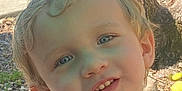 Jaxon is registered to the contest to win money with this photo: child, portrait, face, smile, blue_eyes, blonde_hair, outdoor, nature, tree, close_up, young_child, happy, person, sunlight, casual, daylight, skin, head, expression, curly_hair