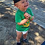 Malow a rejoint le concours — aidez-le/la à gagner de superbes lots ! toddler, child, smiling, cap, green_shirt, diaper, sneakers, standing, outdoor, park, sunlight, shadow, happy, laughing, hands_clasped, pavement, fence, person, grass, cute
