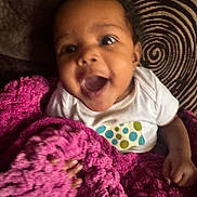 Malaya joined the competition — help win amazing prizes! baby, child, smiling, blanket, pink, knitted, cushion, pattern, spiral, happy, indoors, person, face, infant, clothing, hand, texture, cozy, portrait, cute