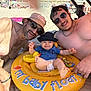 baby, beach, inflatable_float, duck_toy, hat, sunglasses, shirtless, man, child, summer, sand, family, sunny, vacation, outdoor, smile, toy, relaxation, people, fun