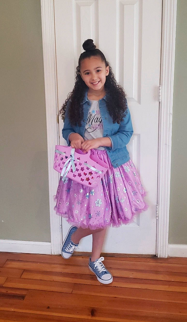 Cherish is registered to the contest to win money with this photo: child, child_model, clothing, costume, dress, footwear, joy, lavender, magenta, pattern, person, pink, purple, room, shoe, smile, toddler, violet