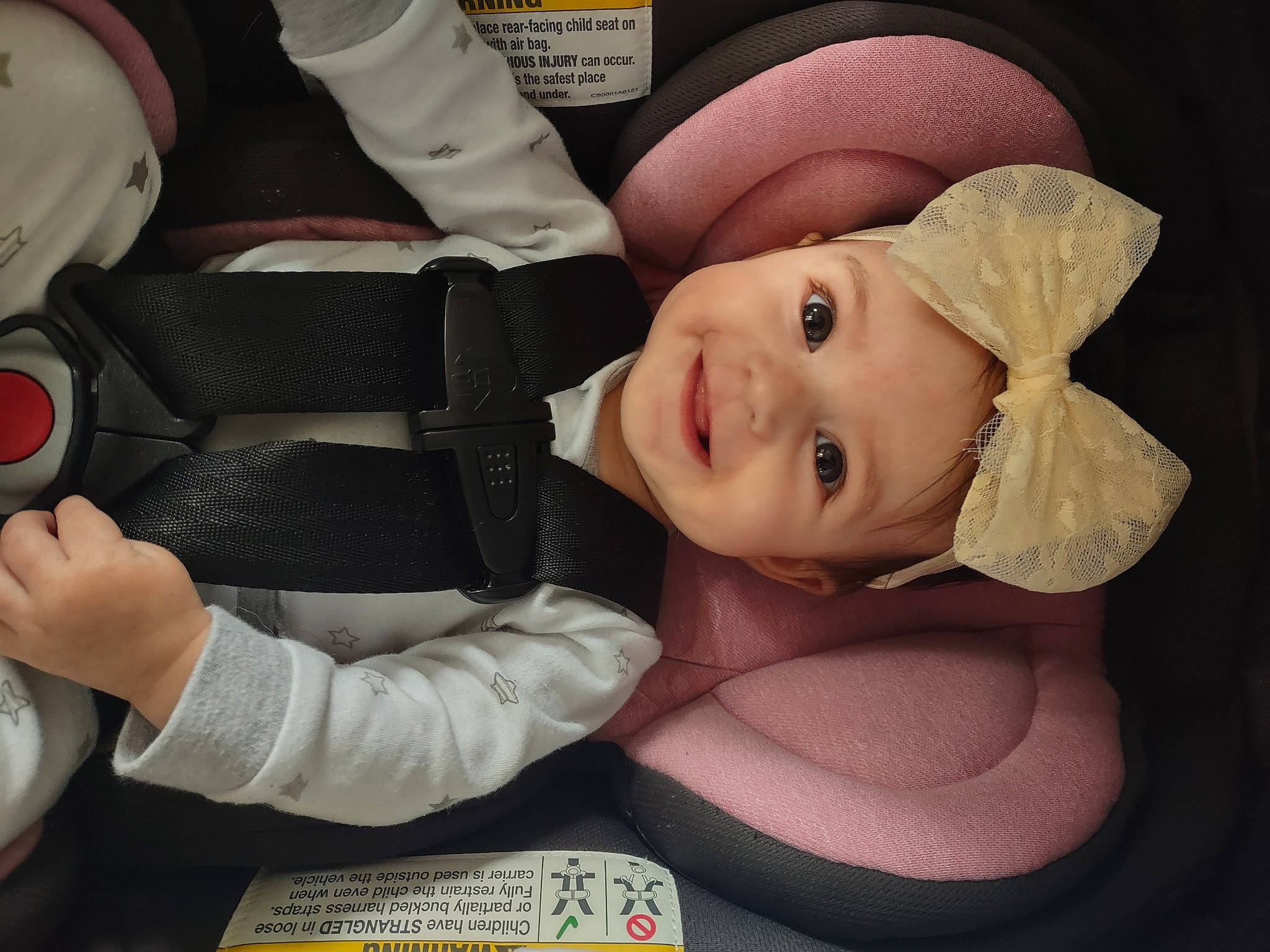Kyla is registered to the contest to win money with this photo: baby, baby_in_car_seat, car_seat, child, comfort, cool, finger, gesture, happy, hat, headwear, joy, lip, mouth, nose, person, skin, smile, steering_wheel, thumb