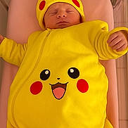 Mattéo participe au concours pour gagner de l'argent avec cette photo : baby, newborn, pikachu, yellow, onesie, sleeping, crib, pink, soft, costume, cute, child, infant, face, headwear, clothing, indoor, resting, adorable, person