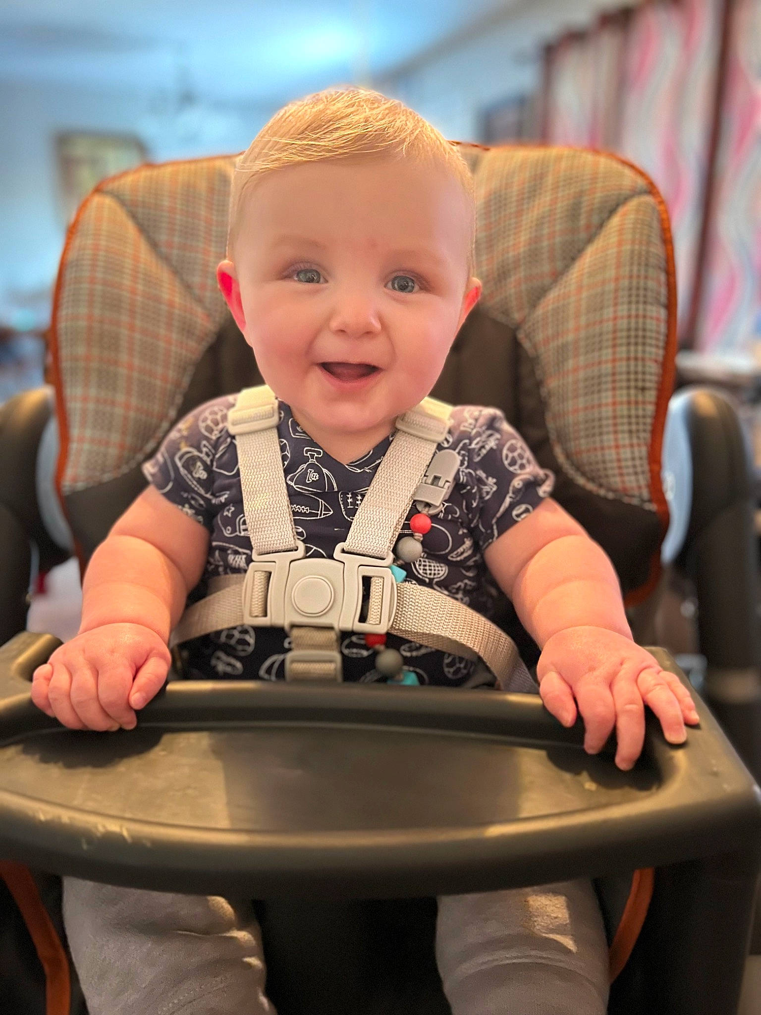 Jaxsyn is registered to the contest to win money with this photo: baby, baby_toddler_clothing, chair, cheek, chin, comfort, facial_expression, finger, fun, furniture, hairstyle, happy, head, human_body, mammal, person, skin, smile, standing, toddler