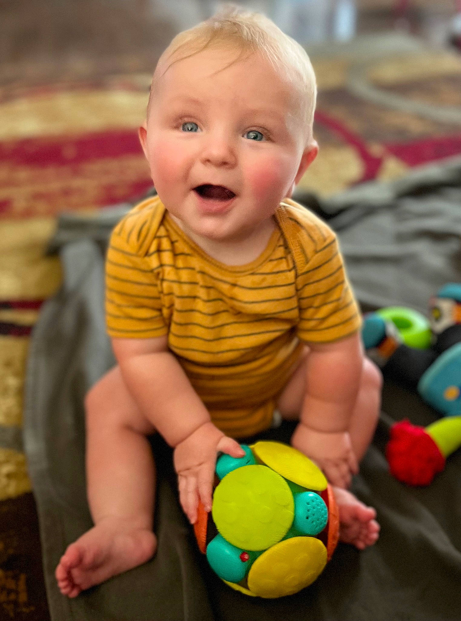 Jaxsyn joined the competition — help win amazing prizes! baby, baby_playing_with_toys, baby_toddler_clothing, ball, cheek, eye, face, fun, hair, happy, head, human_body, iris, person, photograph, product, skin, sleeve, smile, toddler