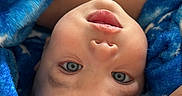 Noah joined the competition — help win amazing prizes! baby, infant, child, portrait, upside_down, blue_blanket, blanket, wide_eyes, open_mouth, lying_down, close_up, face, eyes, nose, lips, skin, cozy, indoor, parent_arm, photography