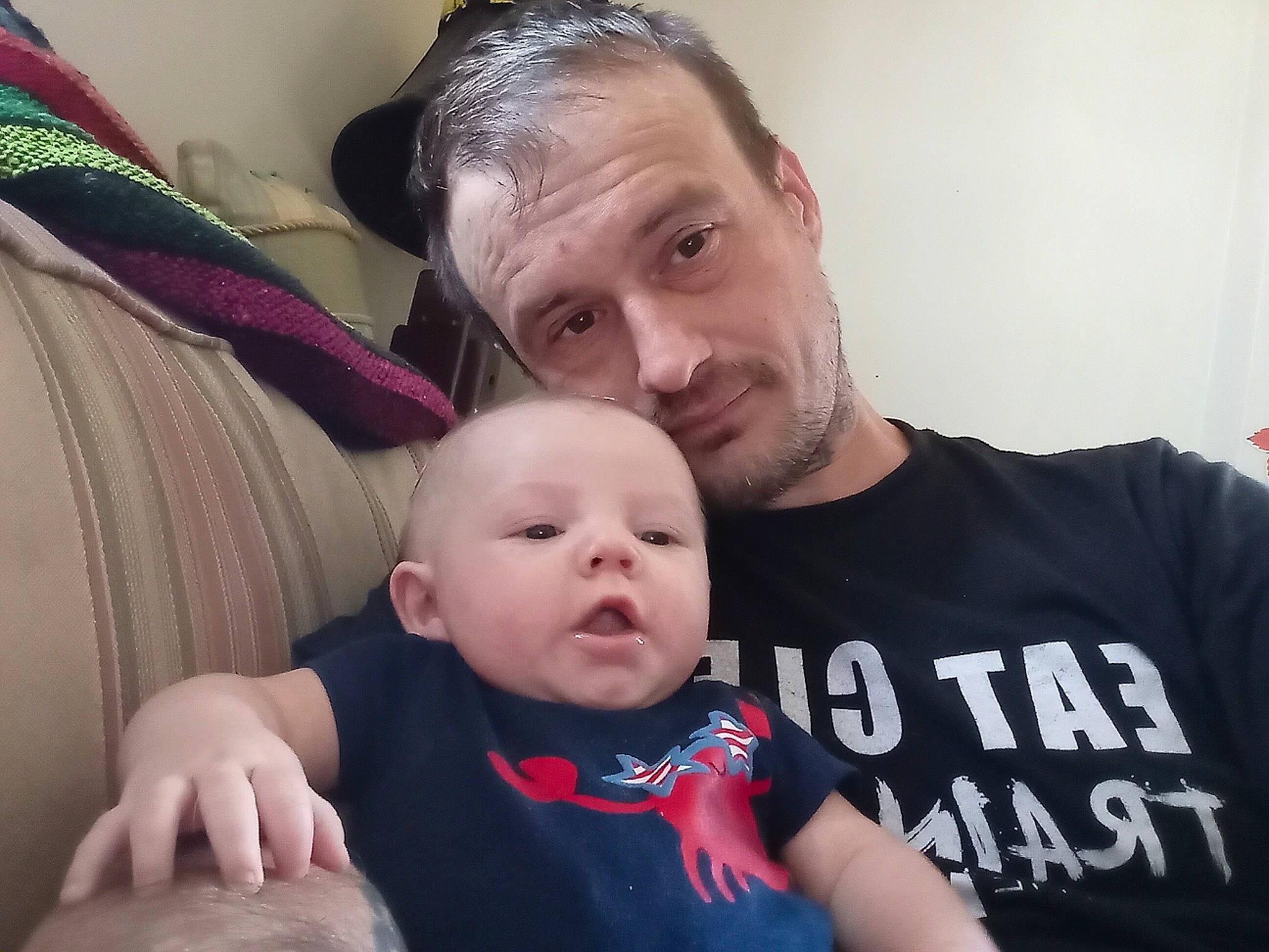 Anubis is registered to the contest to win money with this photo: baby, baby_toddler_clothing, beard, cheek, child, comfort, event, facial_expression, fun, gesture, hairstyle, happy, lap, mammal, person, sitting, sleeve, smile, t_shirt, toddler