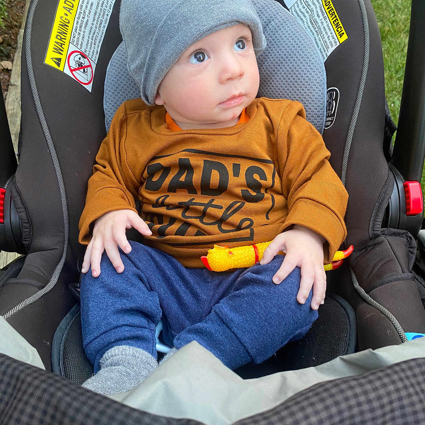 Rowan is registered to the contest to win money with this photo: baby, baseballcap, beanie, cap, car, car_interior, carseat, clothing, coat, face, hat, head, jacket, pants, person, photography, portrait, t_shirt, transportation, vehicle