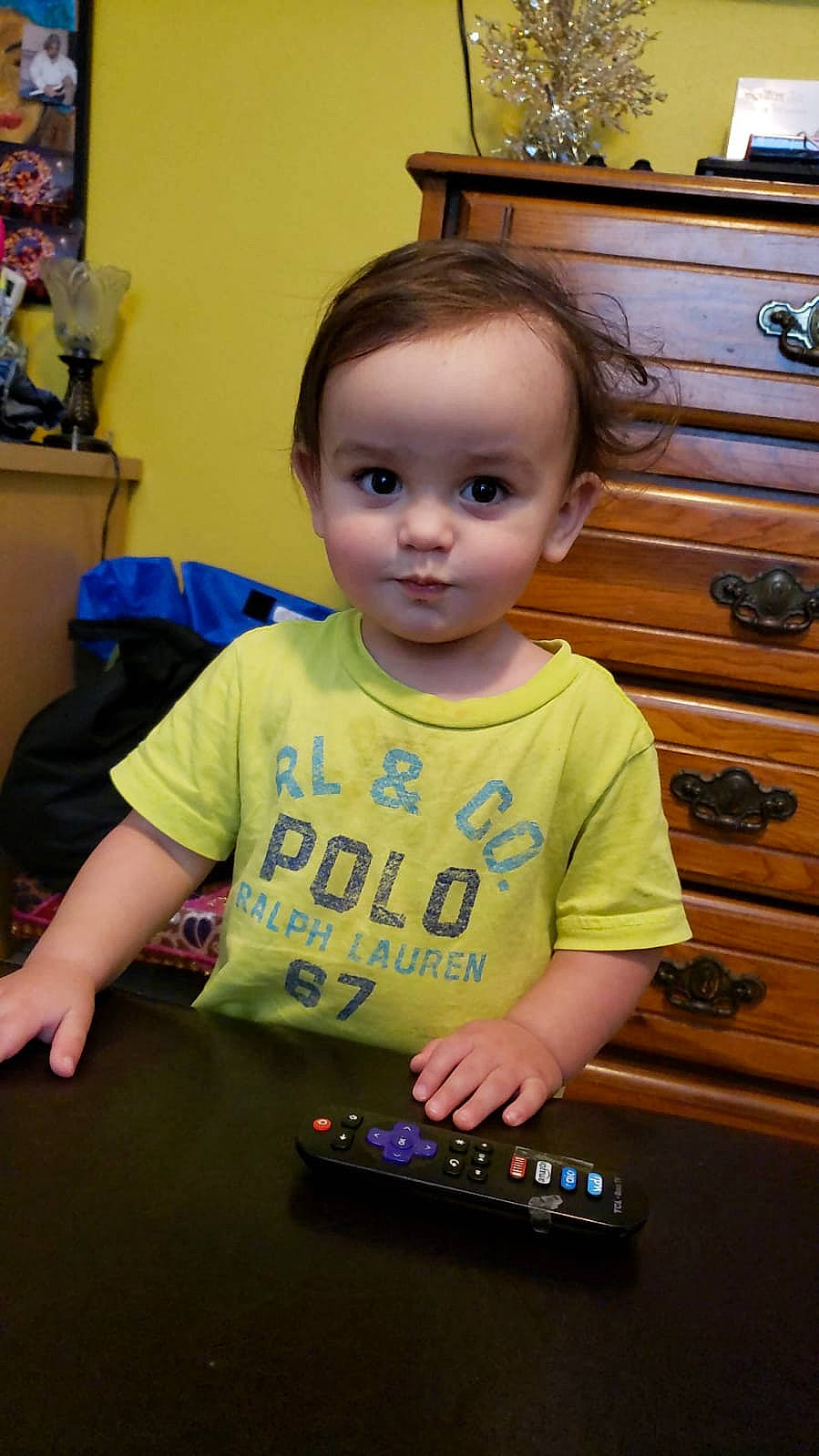 Kristian is registered to the contest to win money with this photo: baby, cheek, child, electronic_device, person, play, t_shirt, technology, toddler, vacation, yellow