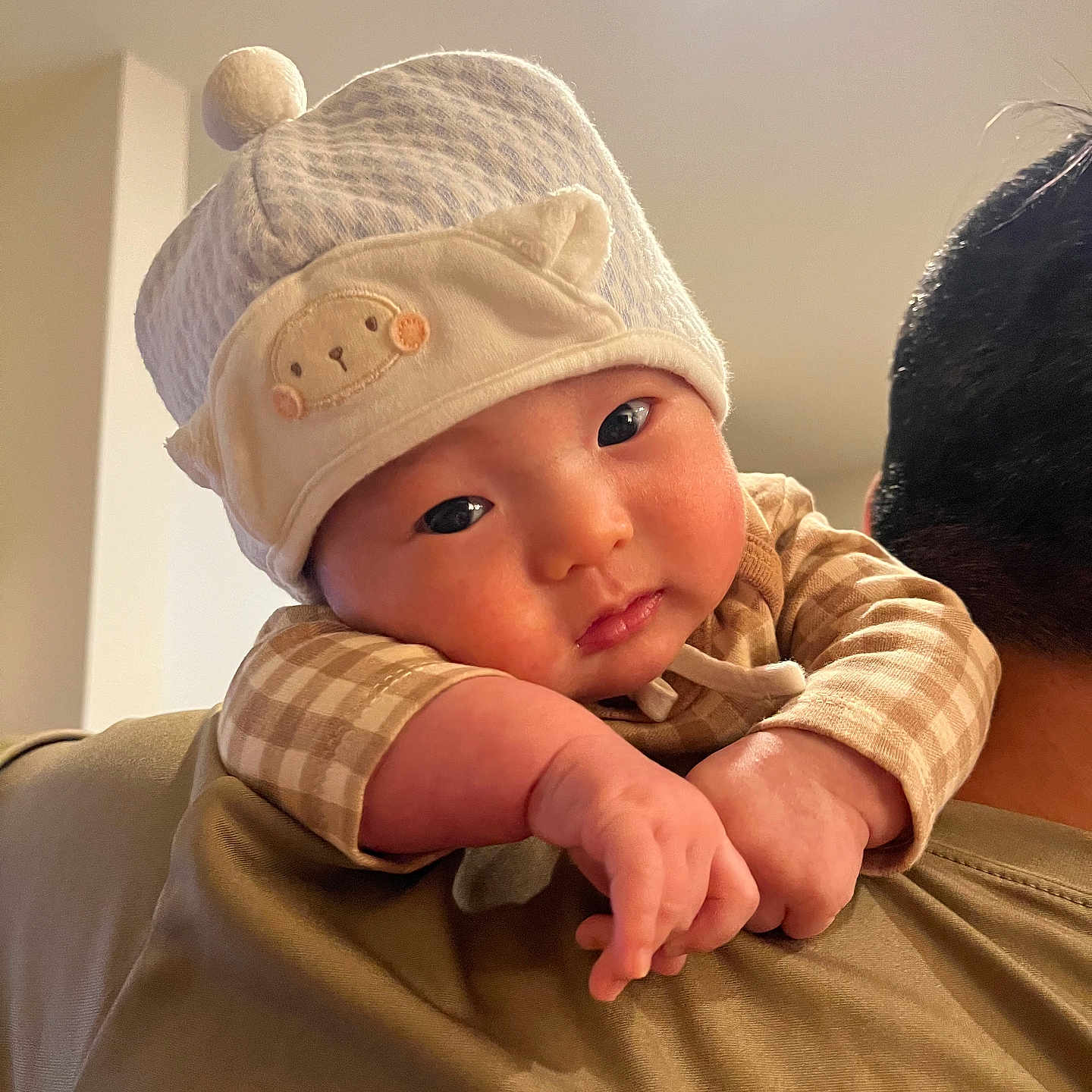 Rian is registered to the contest to win money with this photo: baby, beanie, bodypart, bonnet, cap, clothing, face, finger, hand, happy, hat, head, indoors, knitwear, newborn, pants, person, photography, portrait, smile