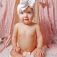 Remington is registered to the contest to win money with this photo: adorable, baby, blue_eyes, bow, butterfly, child, cute, decor, fluffy_rug, headband, indoors, infant, naked, pink_curtains, portrait, sitting, skin, smiling, soft_lighting, toddler