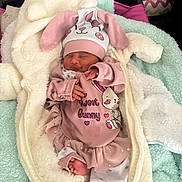 Emma is registered to the contest to win money with this photo: newborn, baby, infant, sleeping, smiling, bunny_hat, pink_clothing, blanket, cozy, cute, soft, toddler, bed, pajamas, child, cute_outfit, indoor, portrait, resting, peaceful