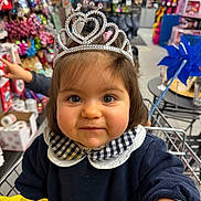 Charlie a rejoint le concours — aidez-le/la à gagner de superbes lots ! child, clothing, collar, colorful, curious, cute, face, hand, happy, indoor, person, pinwheel, portrait, retail, shopping_cart, store, tiara, toddler, toy, young_child