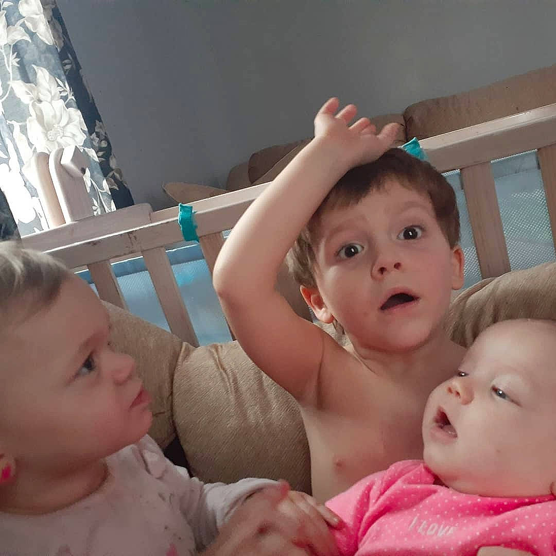 Gannon is registered to the contest to win money with this photo: baby, cheek, child, electronic_device, eye, face, finger, happy, iris, mother, mouth, nose, people, person, product, room, sibling, skin, smile, surprise