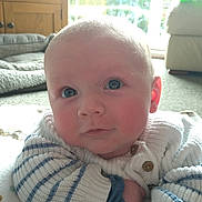 George is registered to the contest to win money with this photo: architecture, baby, building, clothing, computerhardware, couch, electronics, face, furniture, hardware, head, indoors, knitwear, livingroom, person, photography, portrait, room, screen, sweater