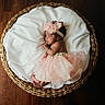 Nymeria is registered to the contest to win money with this photo: baby, basket, blanket, crib, face, furniture, head, infantbed, newborn, person