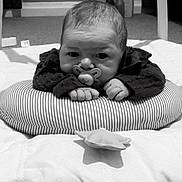 Cecelia-Nevaeh is registered to the contest to win money with this photo: baby, infant, pacifier, cushion, striped, soft_toys, blanket, floor, carpet, radiator, indoors, child, cute, lying_down, black_and_white, clothing, hands, head, face, room