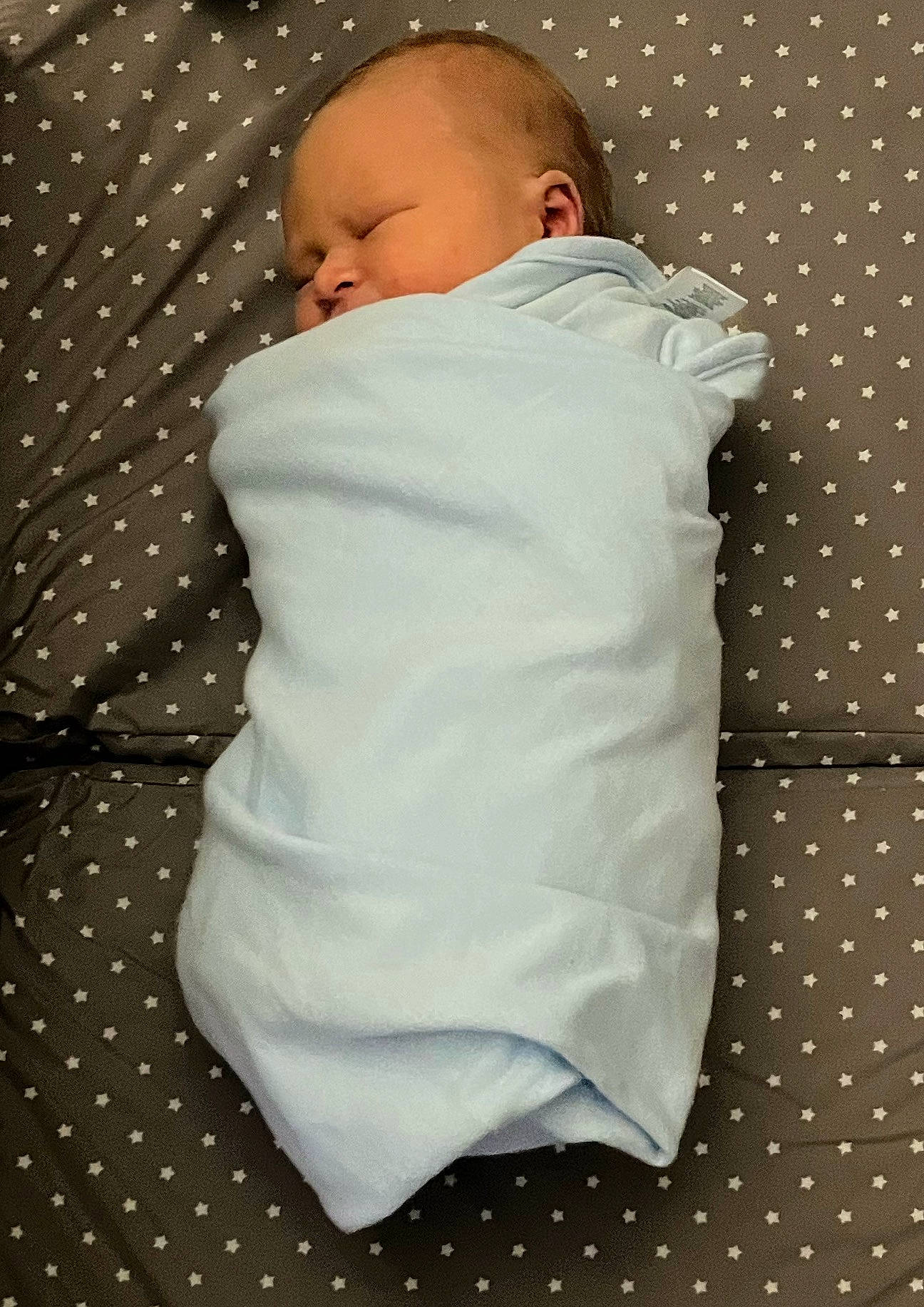 Eddie is registered to the contest to win money with this photo: baby, baby_products, baby_sleeping, baby_toddler_clothing, bedding, cheek, child, comfort, flooring, head, infant_bodysuit, linens, pattern, person, sitting, sleeve, t_shirt, toddler