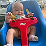 baby, child, swing, blue_swing, red_safety_bar, smiling, happy, outdoor, toy, playtime, infant, seat, clothing, sock, pacifier, yellow_strap, face, person, daylight, nature