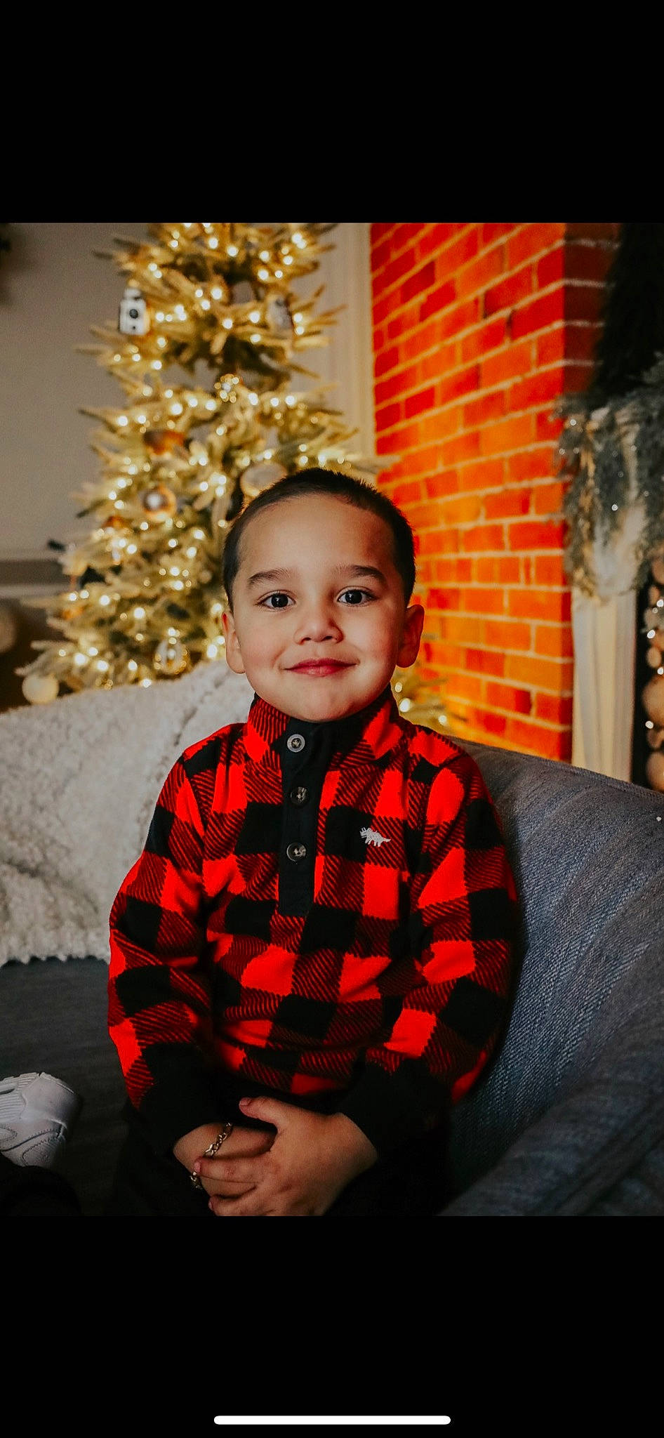 Javian is registered to the contest to win money with this photo: child, christmas, christmas_decoration, christmas_ornament, christmas_tree, couch, event, eye, flash_photography, happy, holiday, joy, pattern, person, plaid, sleeve, smile, standing, tartan, toddler