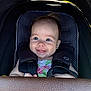 Nora is registered to the contest to win money with this photo: baby, baby_clothes, black_fabric, blue_eyes, car_seat, child, childcare, closeup, cute, drool, hair_tuft, handlebar, happy, indoor, infant, portrait, safety, seatbelt, sitting, smile