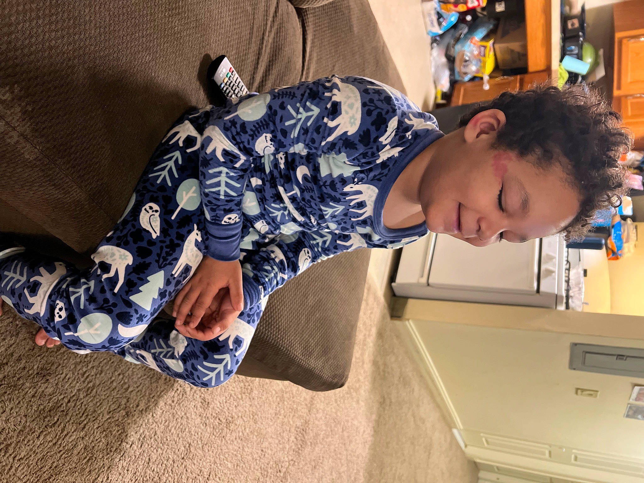 Daymian is registered to the contest to win money with this photo: box, child, comfort, elbow, electric_blue, eyewear, fun, human_leg, joy, leisure, pattern, person, play, room, shelf, sitting, sleeve, soil, t_shirt, thigh