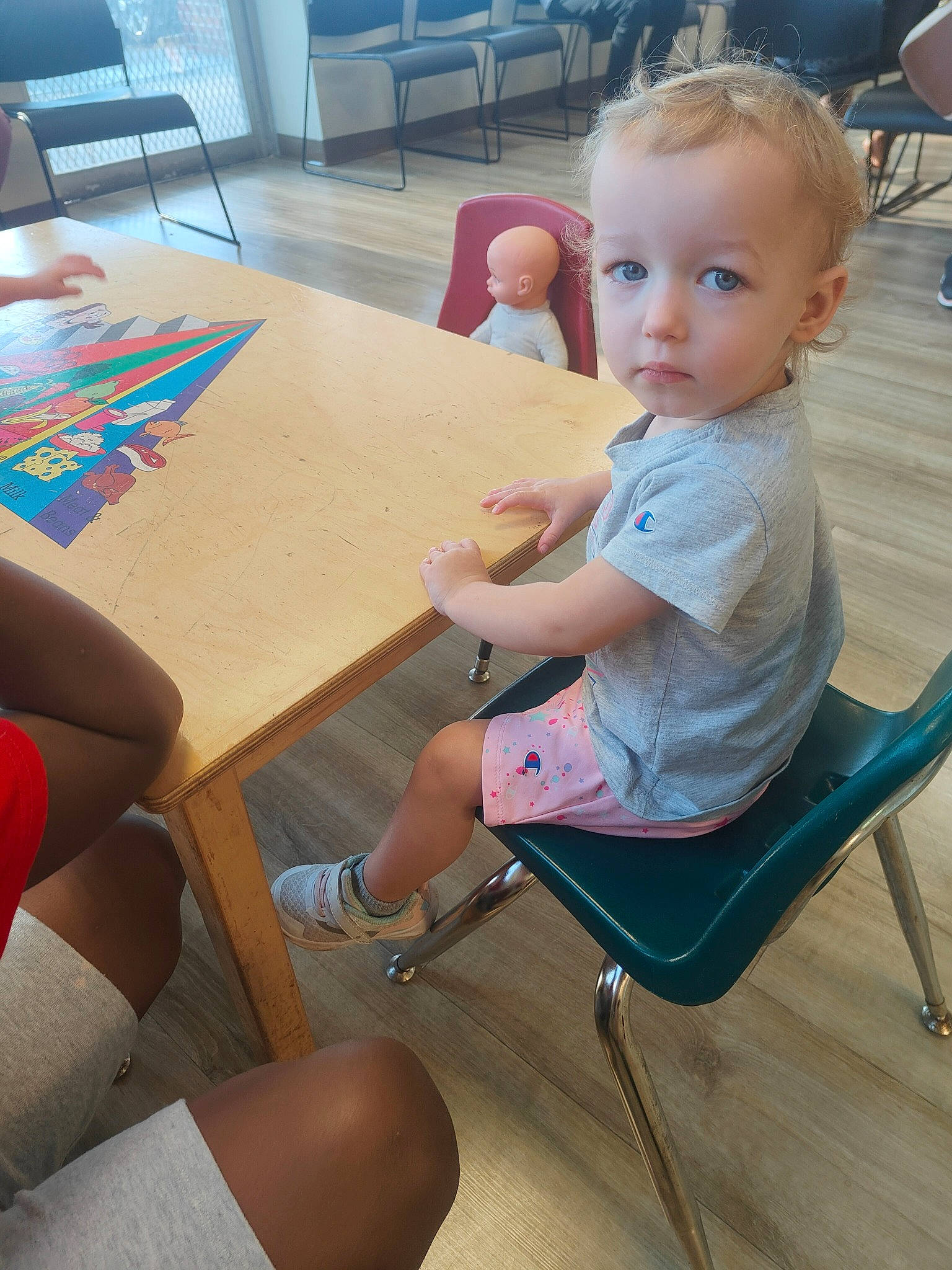 Wynona joined the competition — help win amazing prizes! baby_toddler_clothing, chair, child, comfort, floor, flooring, fun, furniture, human_body, human_leg, joint, lap, leg, leisure, person, sitting, standing, table, thigh, toddler