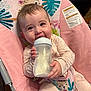 Everleigh joined the competition — help win amazing prizes! baby, bottle, milk, pink, baby_seat, animal_print, happy, smiling, child, infant, clothing, indoors, cushion, feeding, cute, person, portrait, seated, milk_bottle, baby_clothes