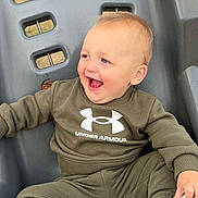 Grayson joined the competition — help win amazing prizes! toddler, child, swing, outdoor, smiling, happy, clothing, socks, playground, seat, person, casual_wear, green, plastic, fun, joy, baby, sitting, cute, playtime